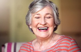 Woman smiling wide in her home